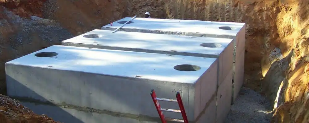 Septic tank installation site with a newly placed concrete tank in Kansas City, KS